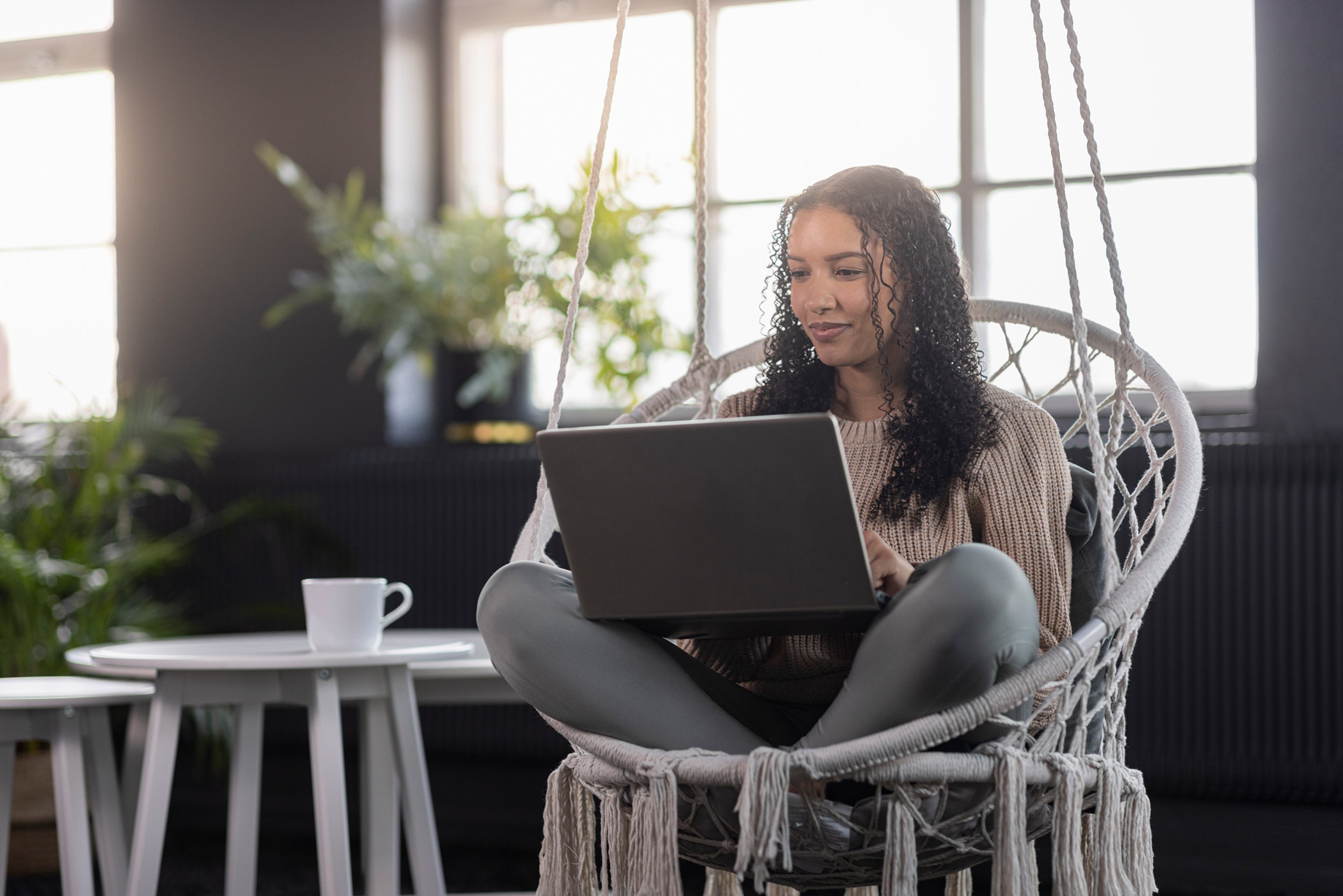 Girl sitting in chair with computer.
