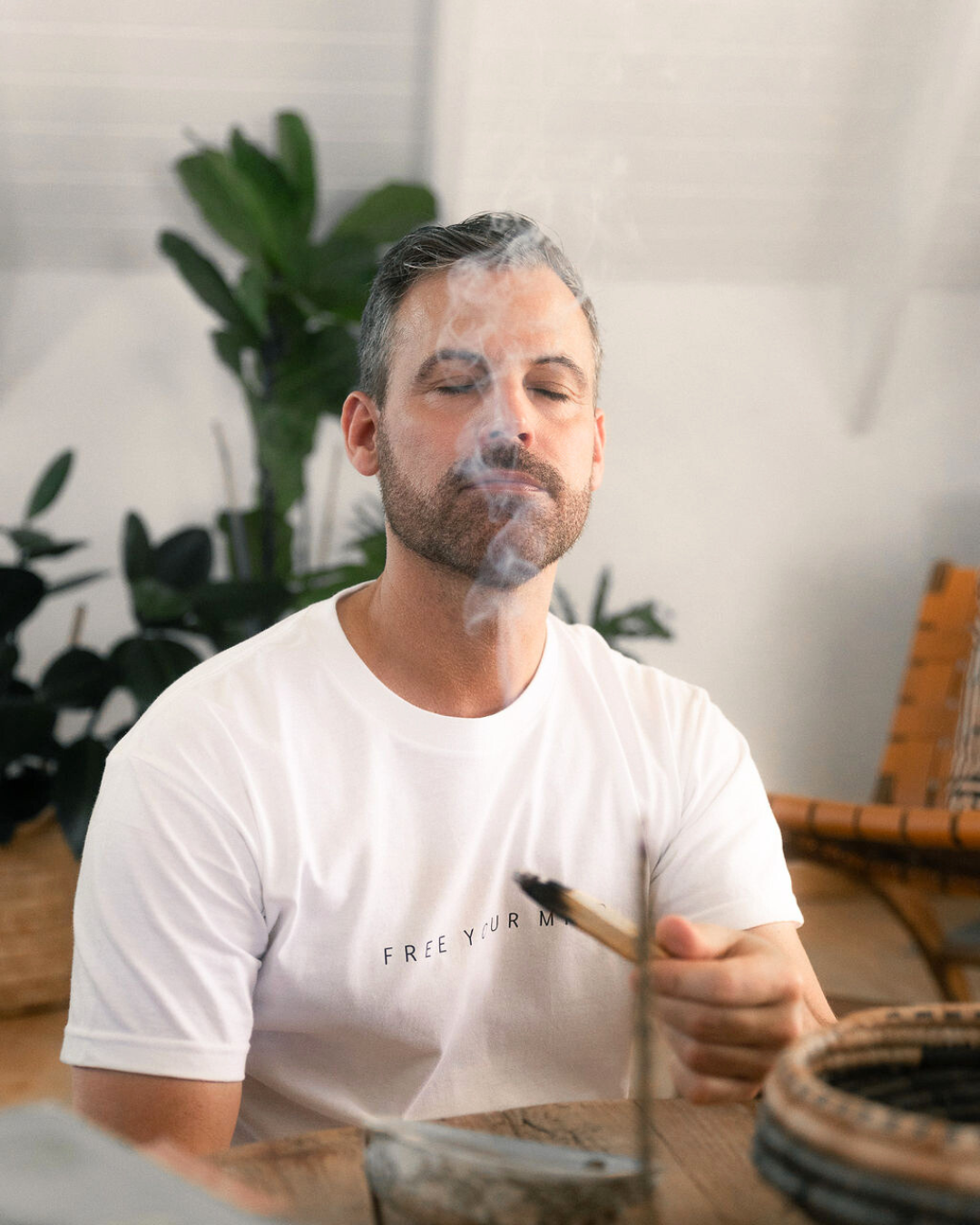 A man smelling incense.